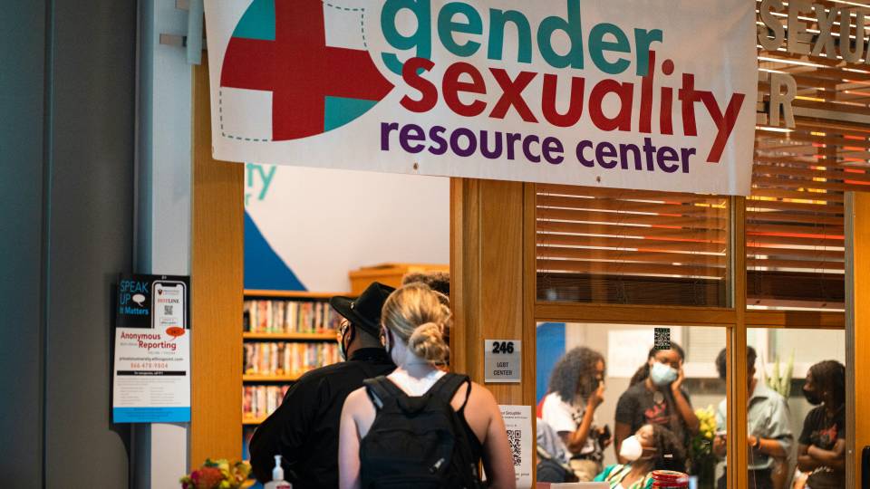 Students mingle at a Gender + Sexuality Resource Center reception.
