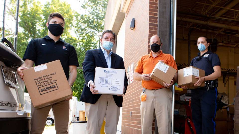 University staff wearing masks helping with the University donations of PPE in 2020