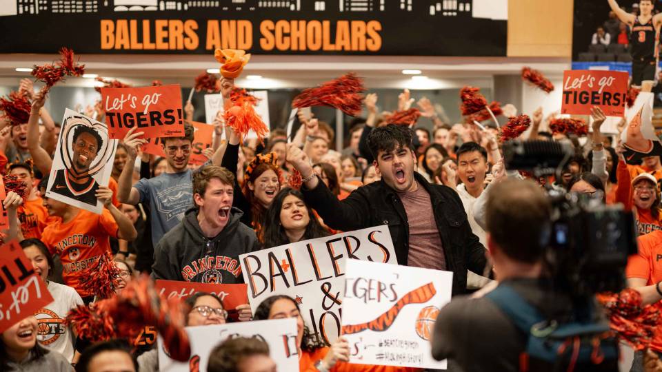 Students cheering in support of the Princeton basketball team