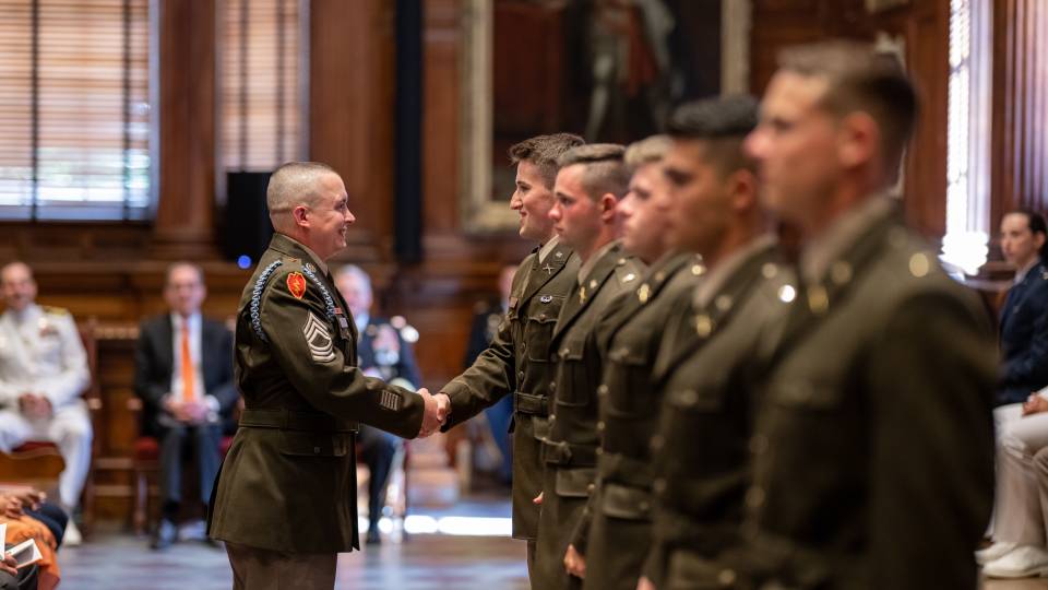 ROTC sergeant congraulates new commissioned officers