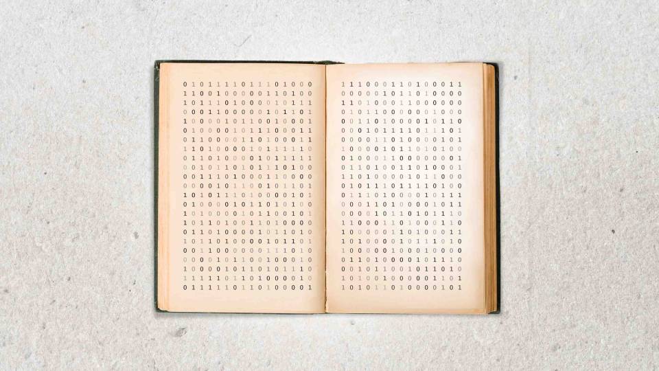 Opened book containing written binary code