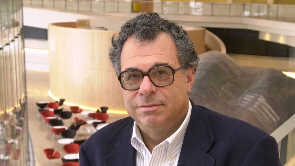 Portrait of David Botstein in glasses and a suit jacket