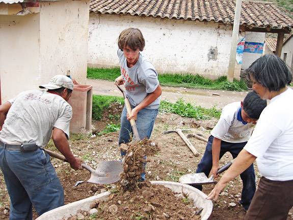 David Hammer shoveling dirt into wheelbarrow