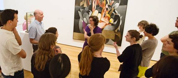 discussion in front of abstract painting