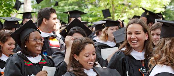 Celebrating students toss hats