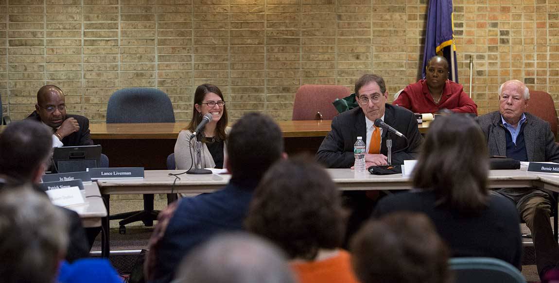 From left: Princeton Council President Lance Liverman, Mayor Liz Lempert and Council member Bernie Miller listen to Eisgruber during the public meeting at the Monument Hall municipal building.