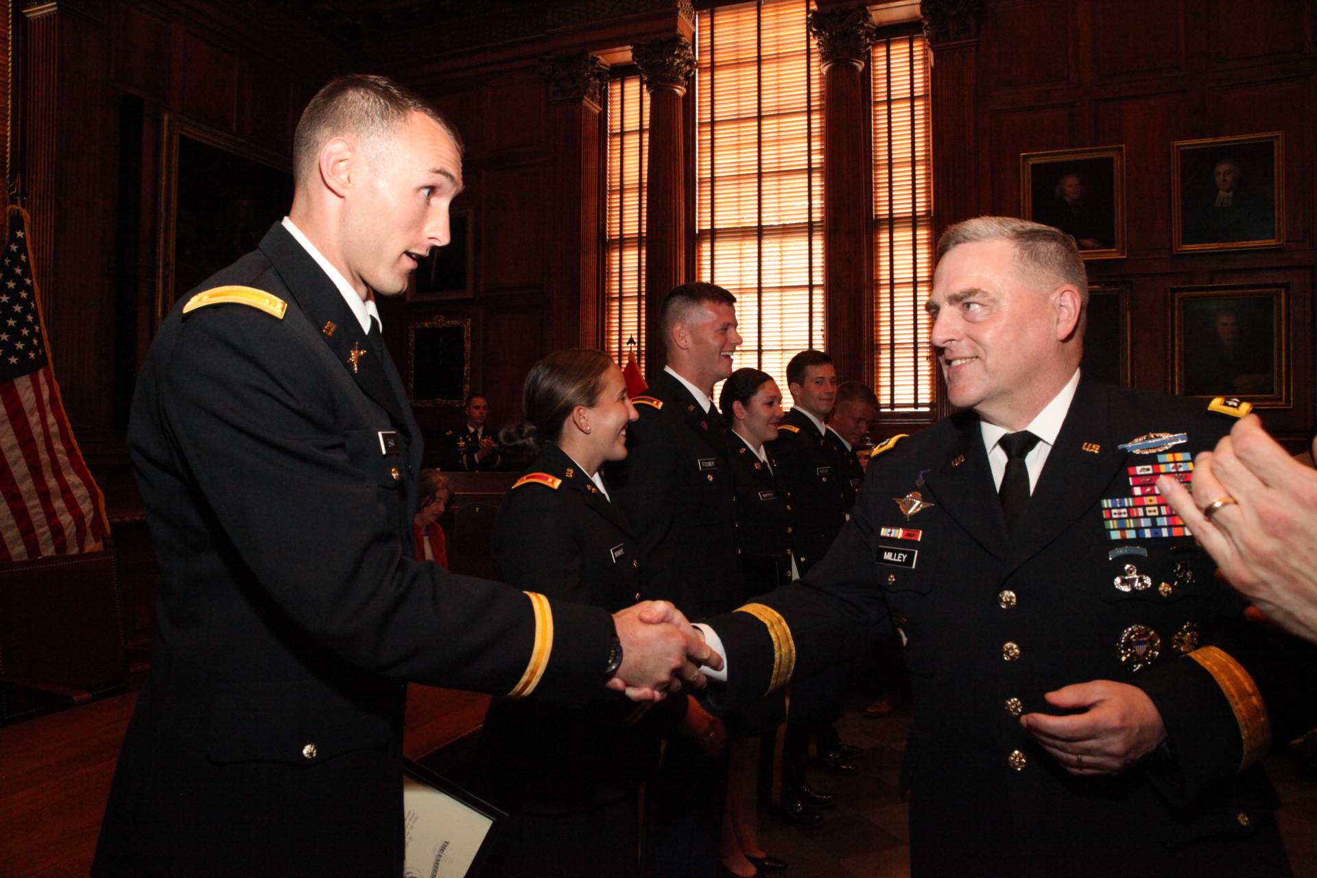 Mark Miley congratulates a student of ROTC