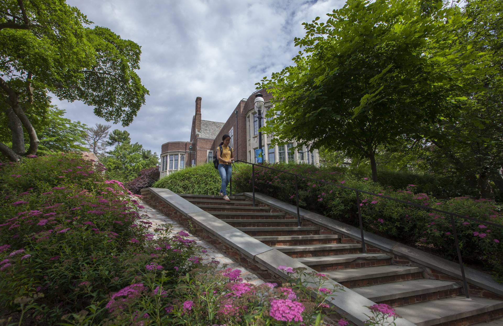Student walking down stairs by McCosh
