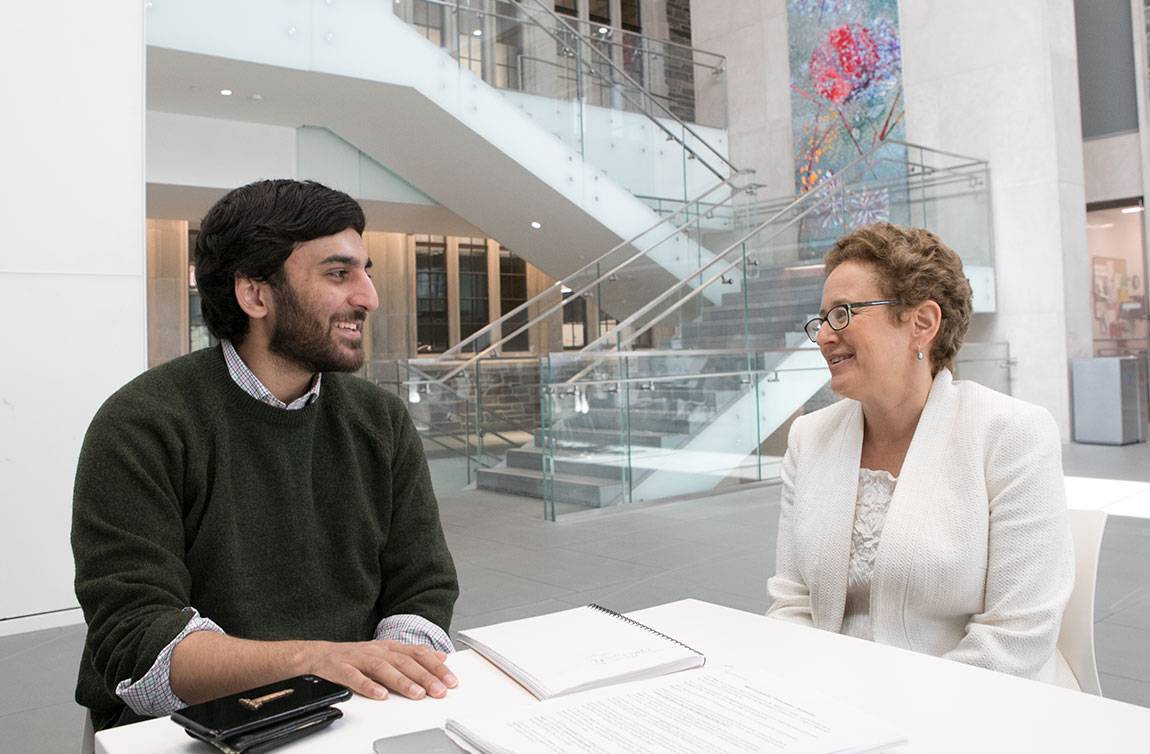 Nabil Shaikh '17 with senior thesis advisor, Professor Melissa Lane, in the cafe of the Simpson International Building
