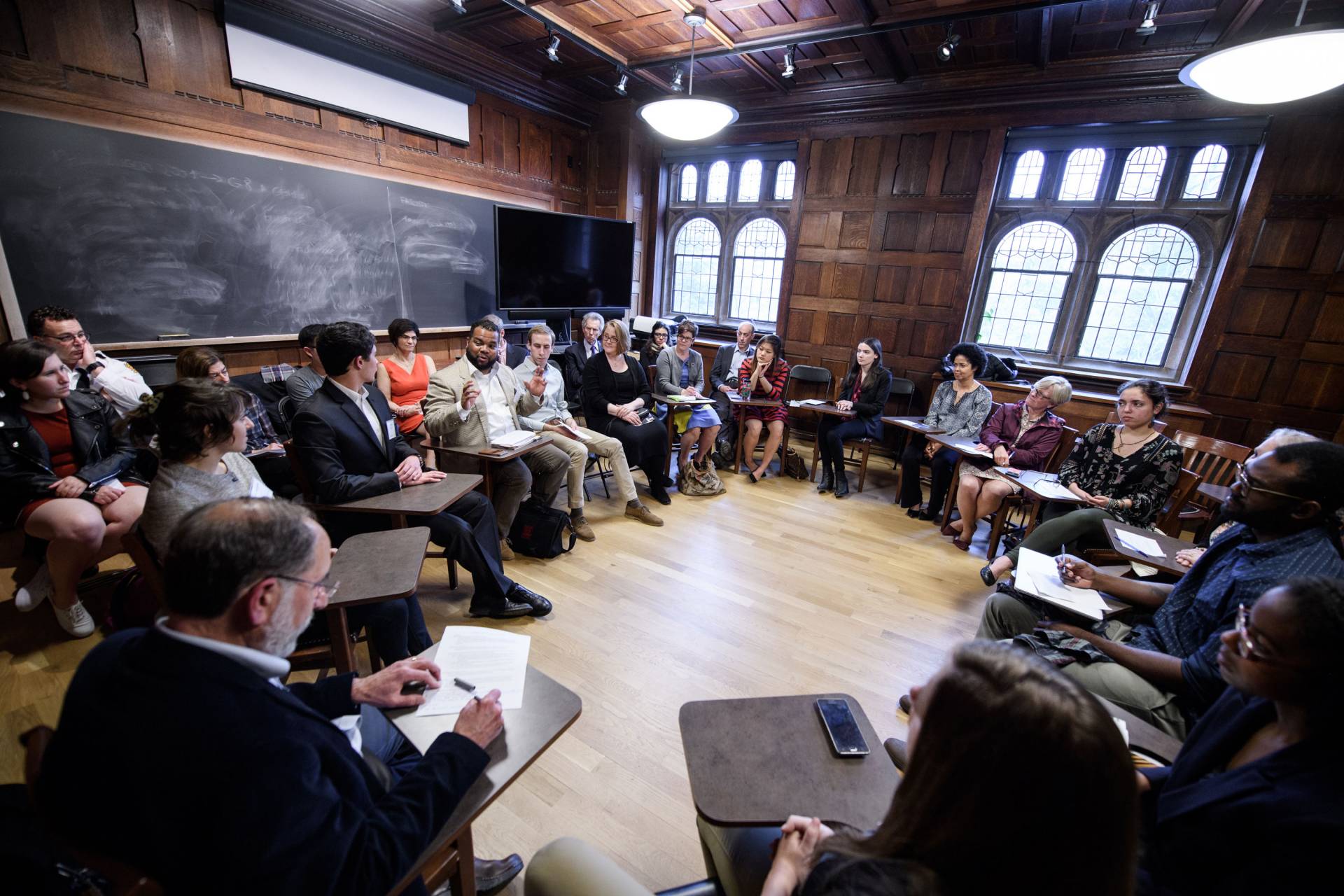 A group sits at desks in a circle during a panel as part of Celebrating Service at Princeton