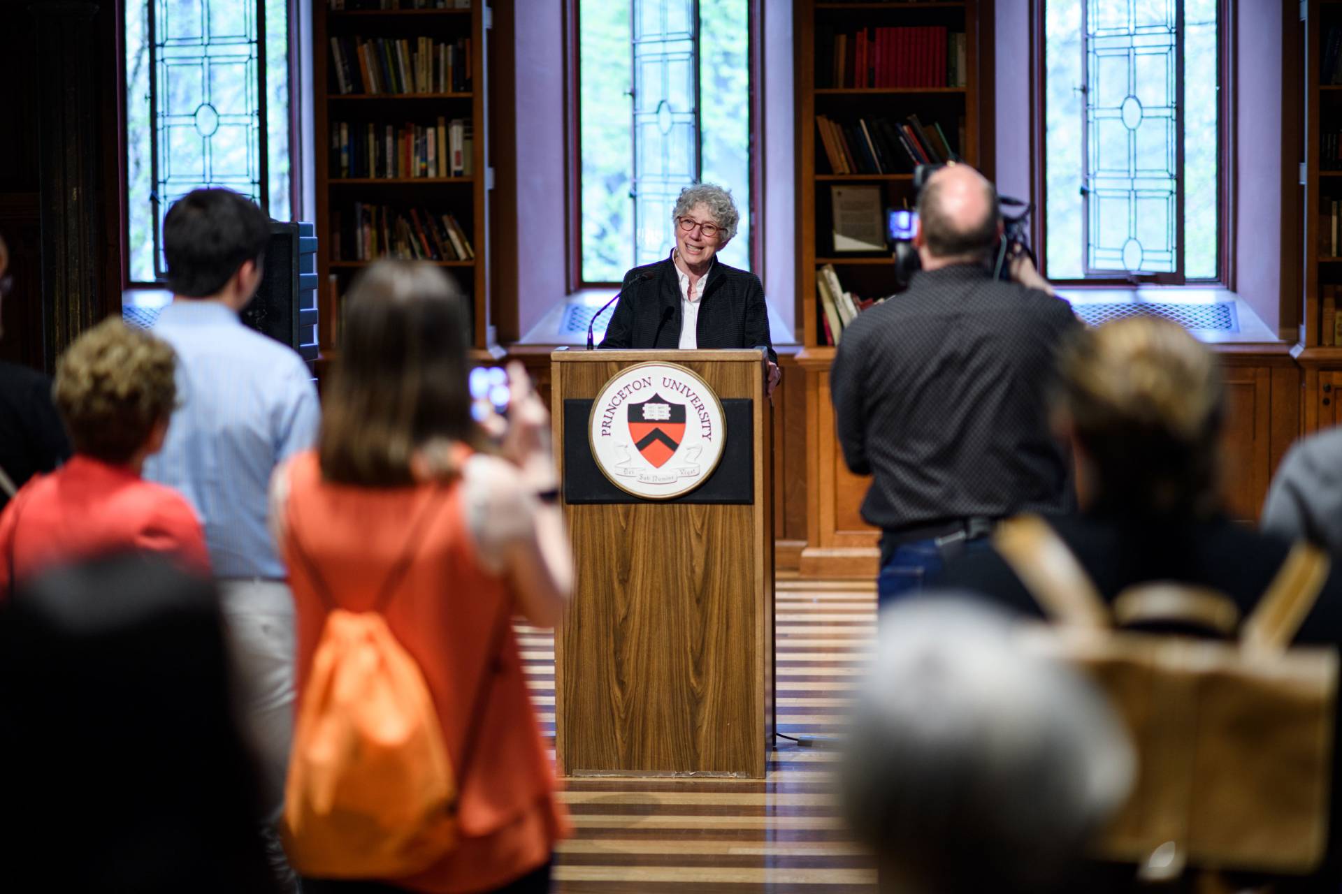 Jill Dolan stands at a podium and speaks to crowd at Celebrating Service at Princeton