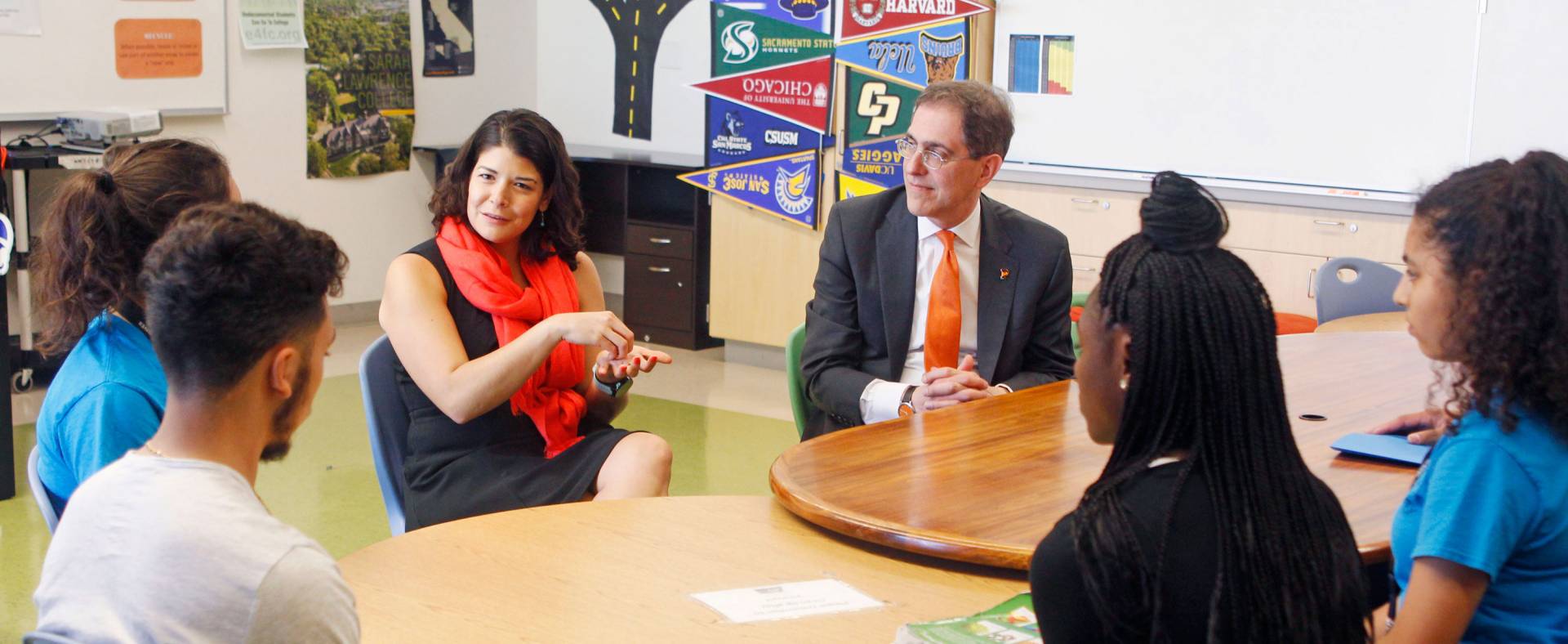 President Eisgruber and Khristina Gonzalez sit at a table, speaking with high school students