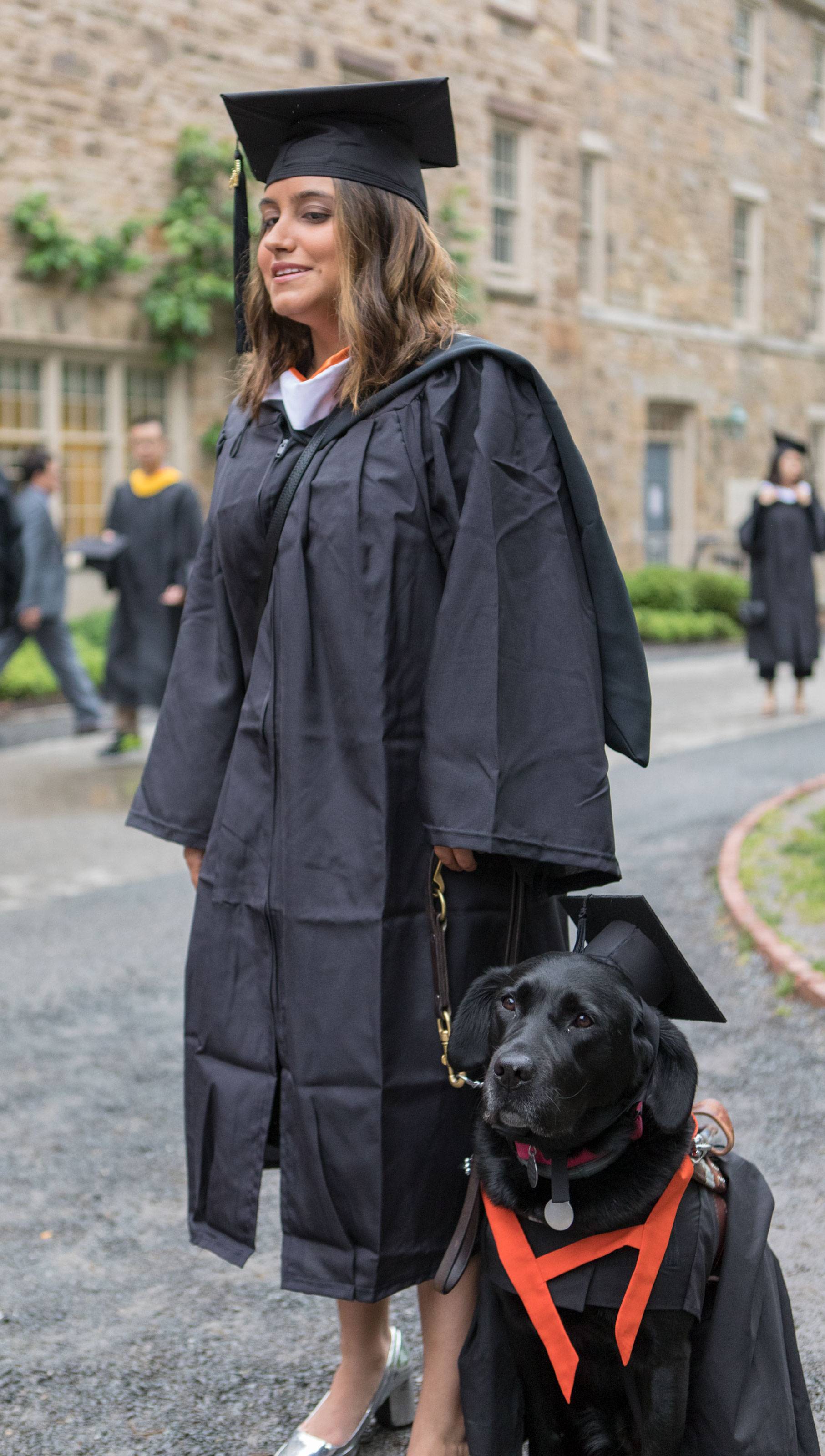 Sofia Gallo processes with her guide dog
