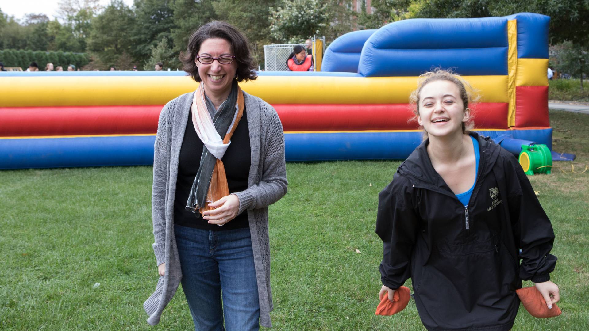 Sabrina Evoy and mother Nicole Evoy tossing beanbags on Poe Field