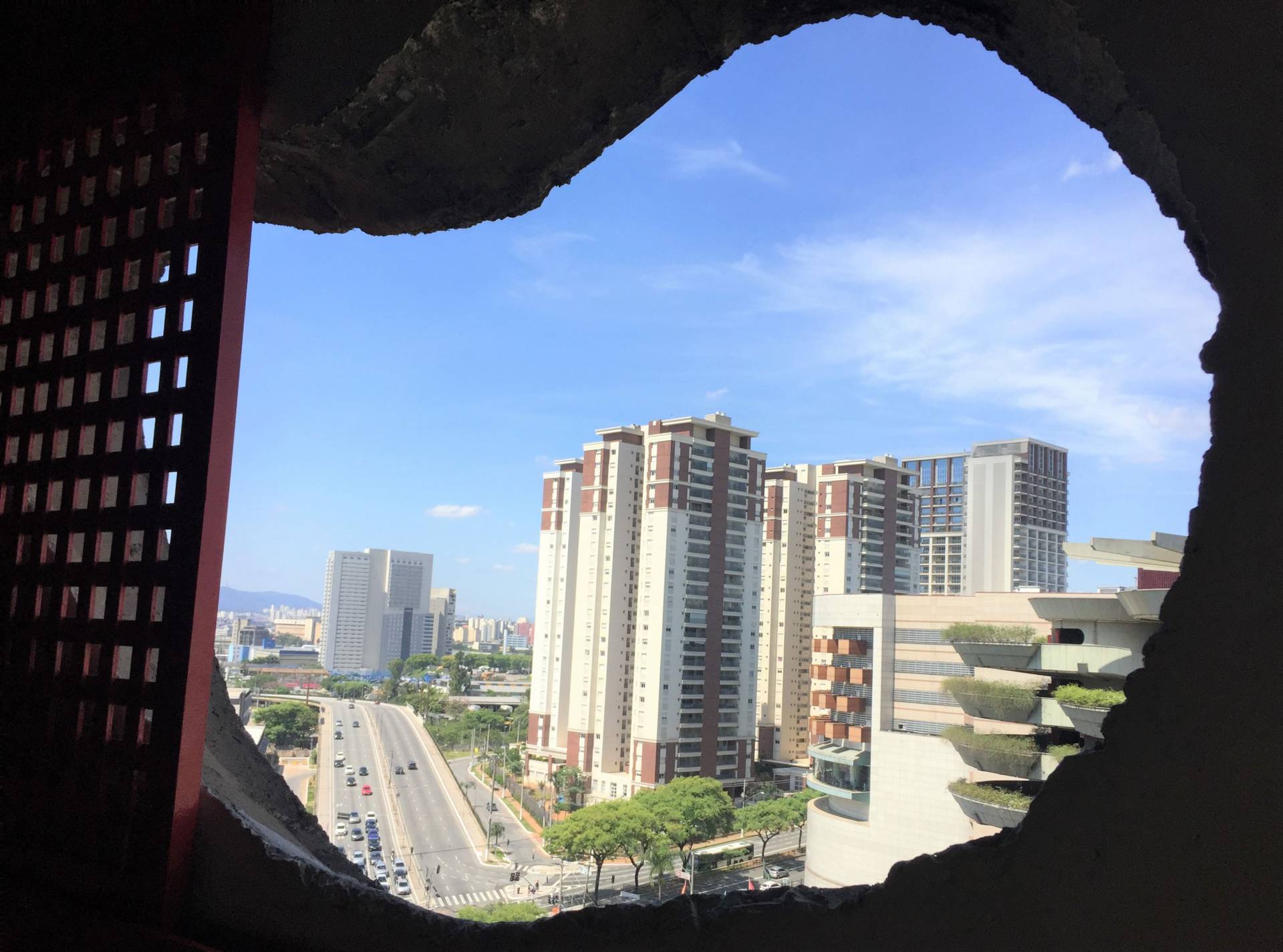 São Paulo vista seen through hole in a wall
