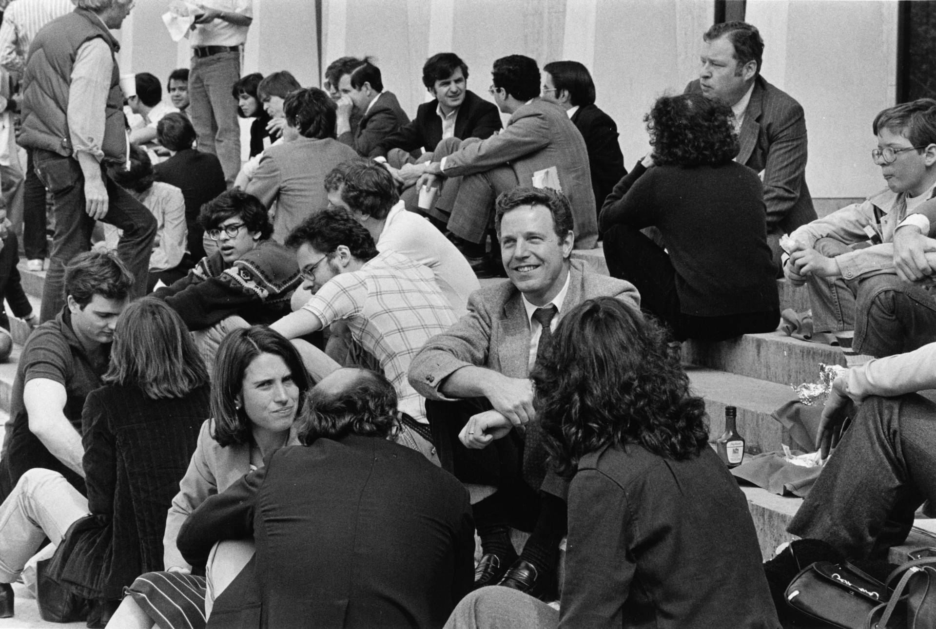 Uwe Reinhardt sitting with students on stairs of Robertson Hall