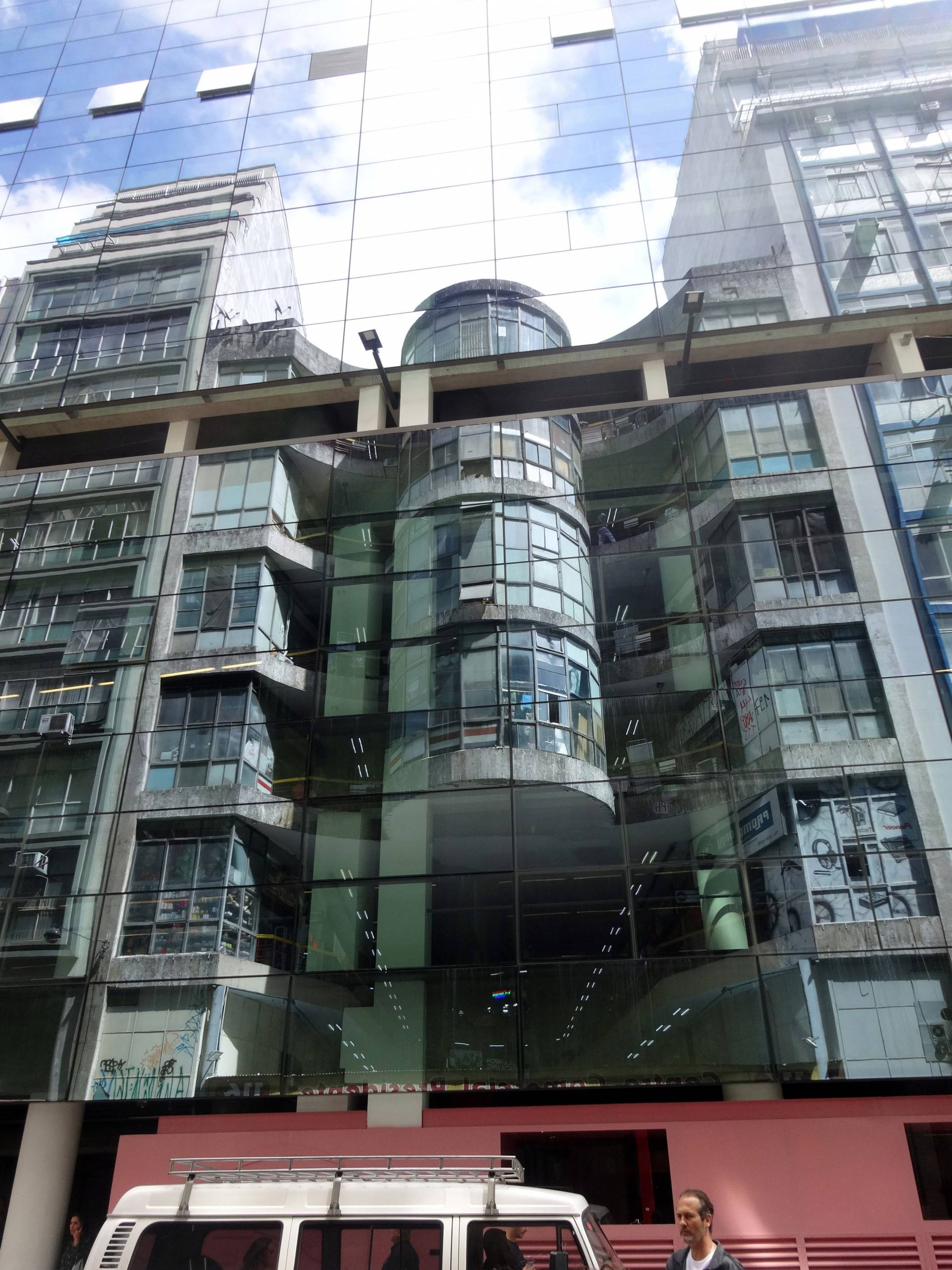 Department store reflected from glass facade of building