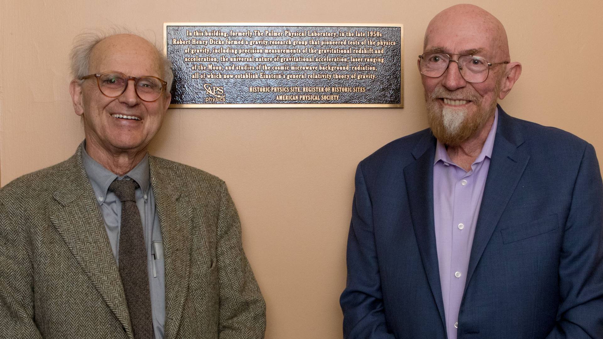 Rainer Weiss and Kip Thorne stand next to a plaque commemorating physics work of Robert “Bob” Dicke