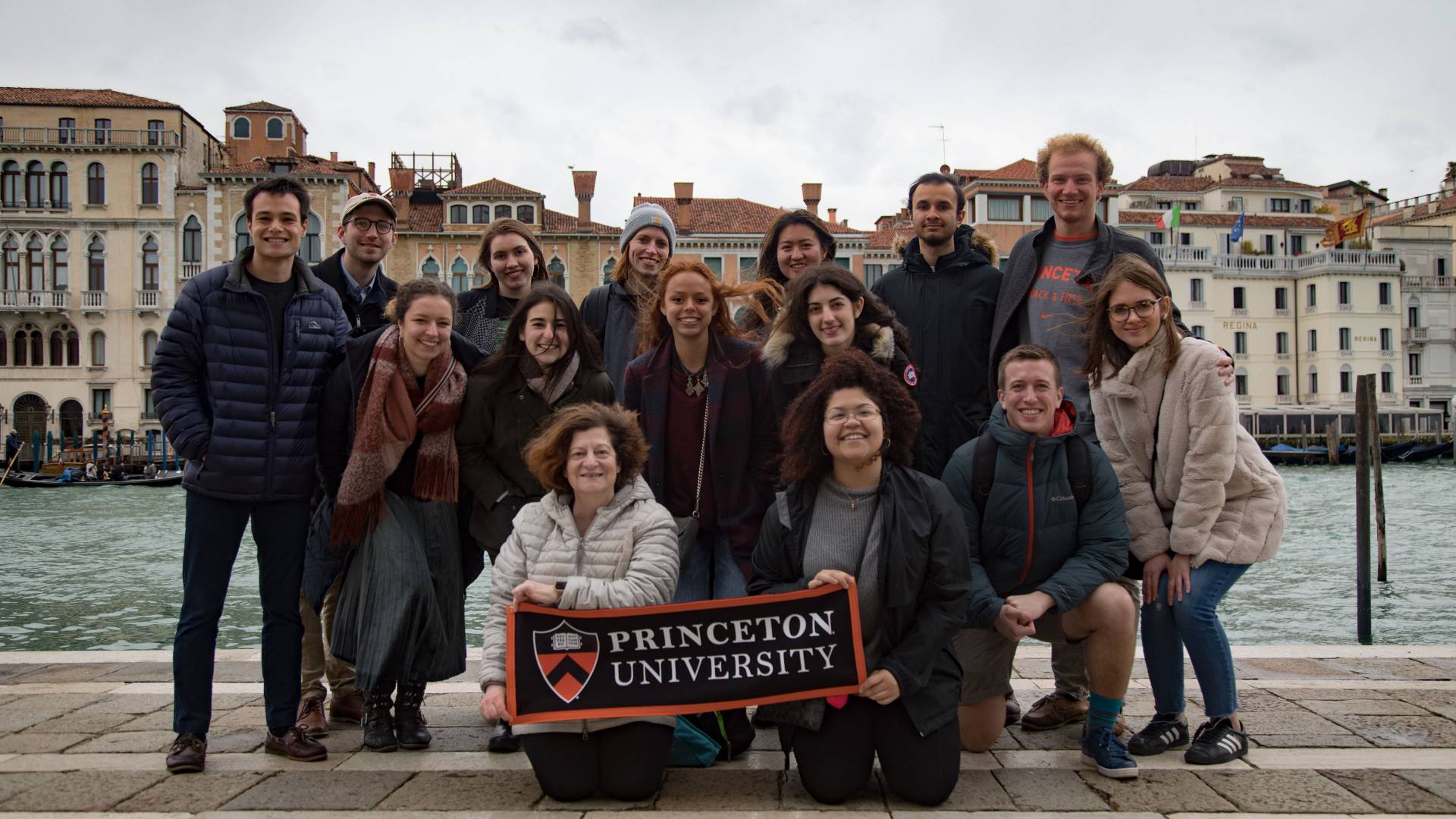 Students and professors in Venice holding Princeton University banner