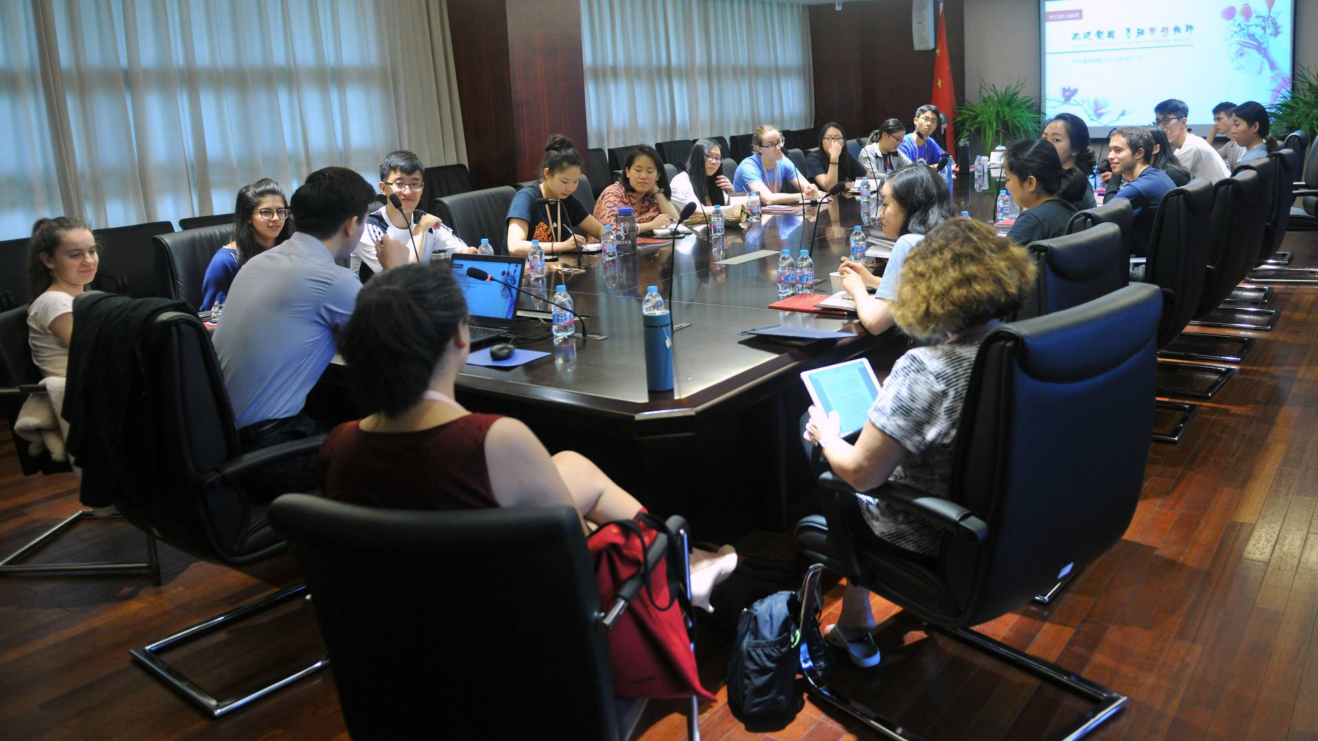 Students and guest sitting at conference table