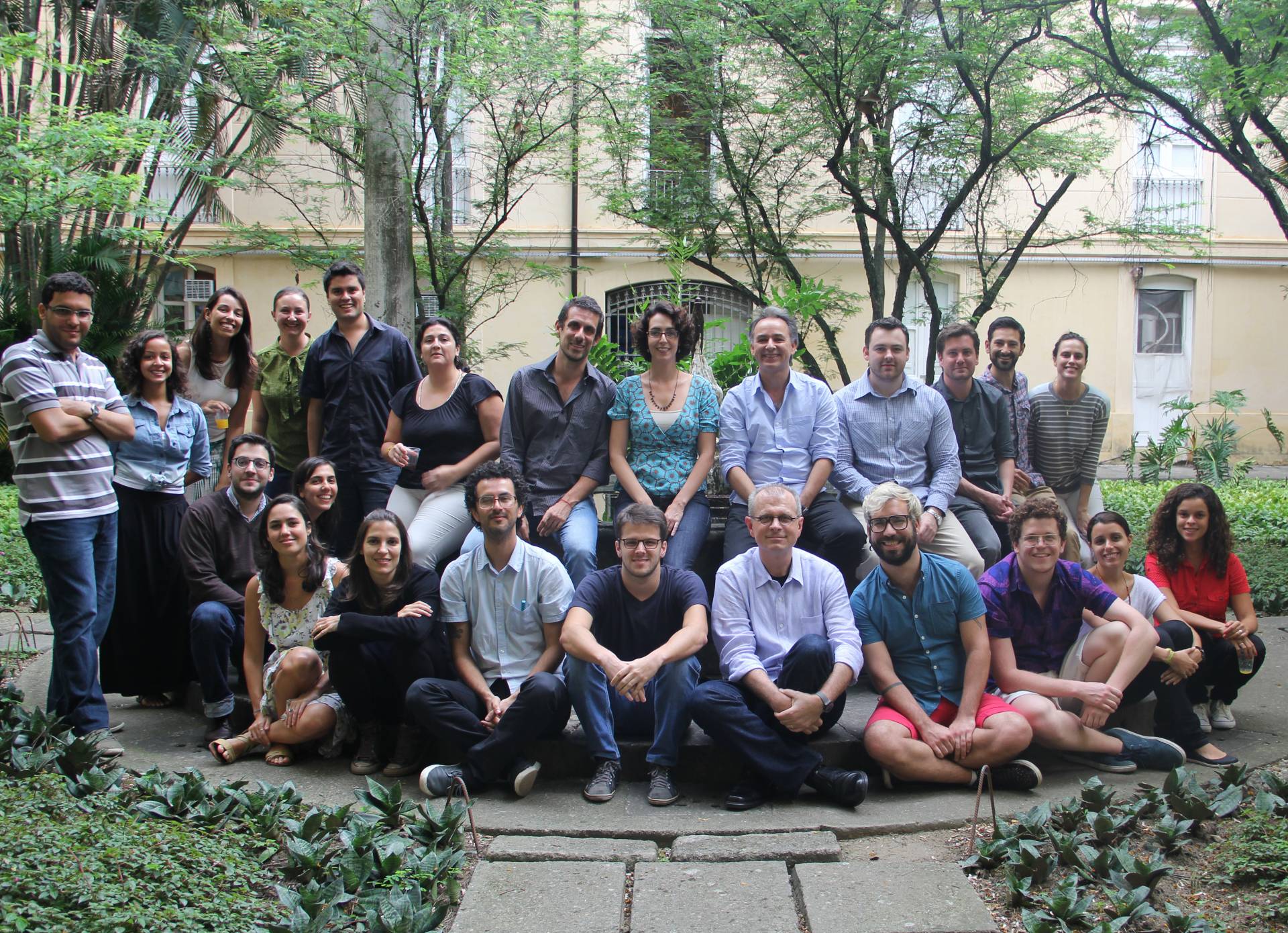 Group of researchers and students pose in a garden in Brazil