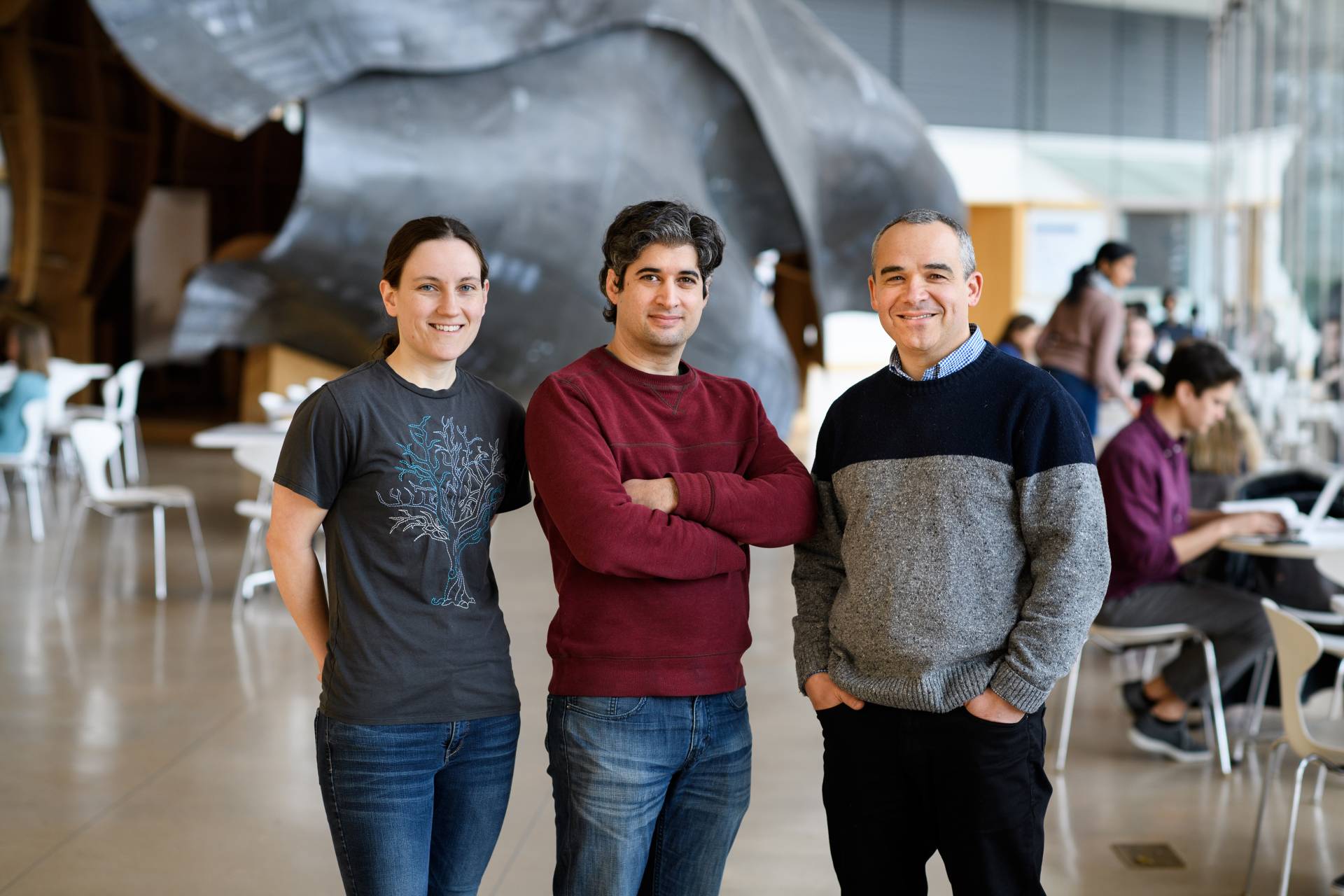 3 researchers in front of the sculpture in the Icahn Laboratory