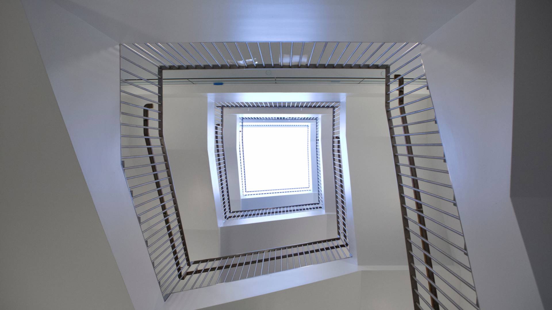 Looking up through a stairwell into a skylight