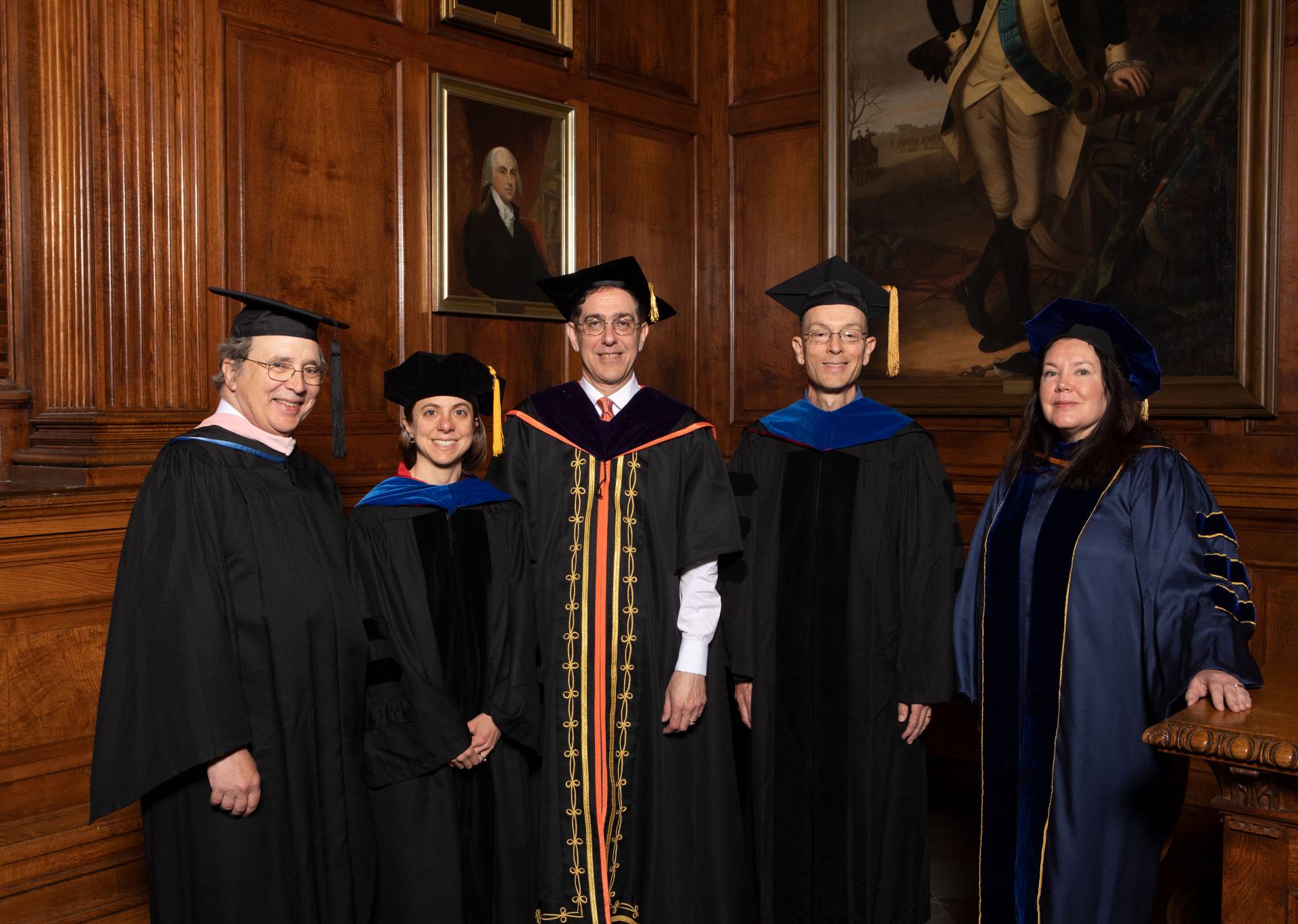 Recipients of faculty teaching awards pose in their ceremonial robes and mortarboards