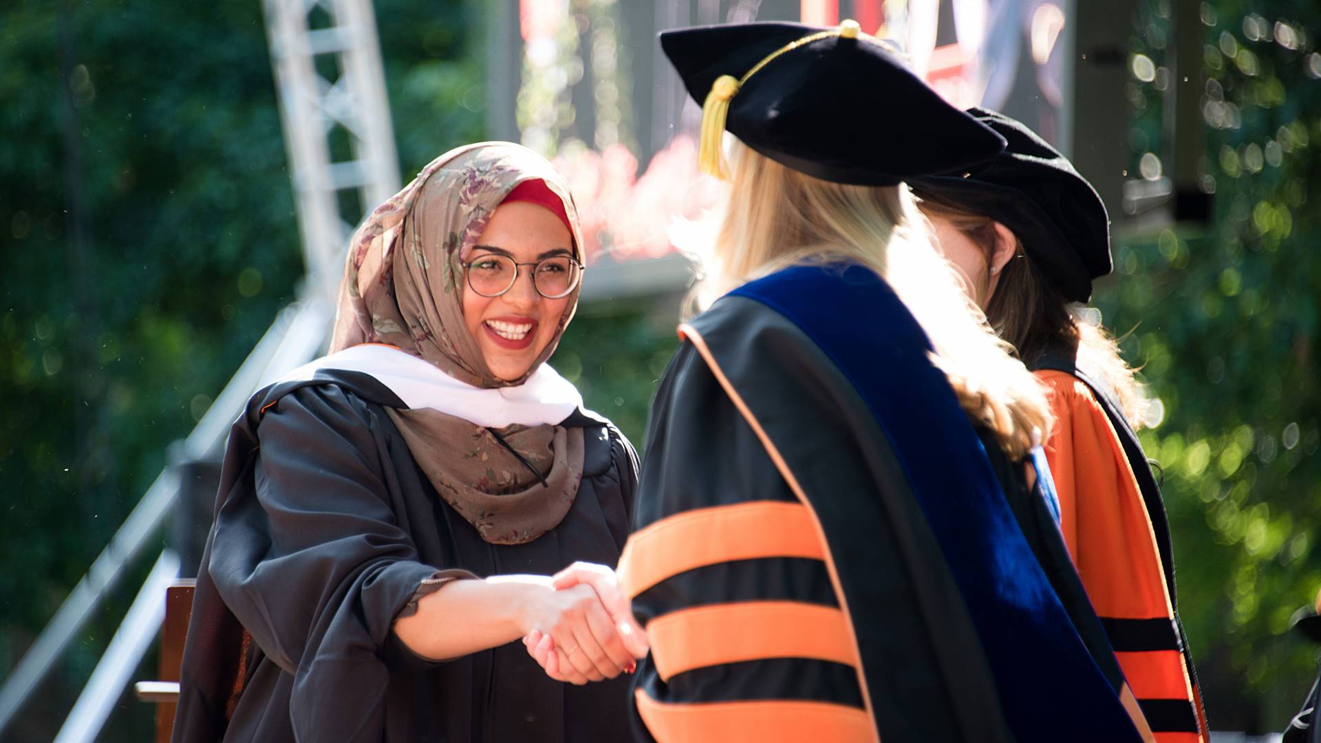 Wafa Fatima Isfahani shaking hands with Dean Leslie