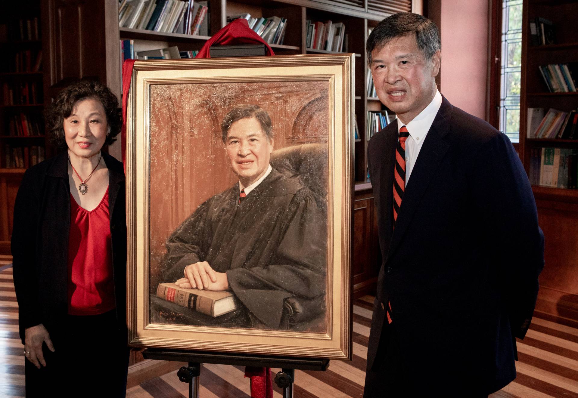 The subject of the painting and his wife pose in front of it