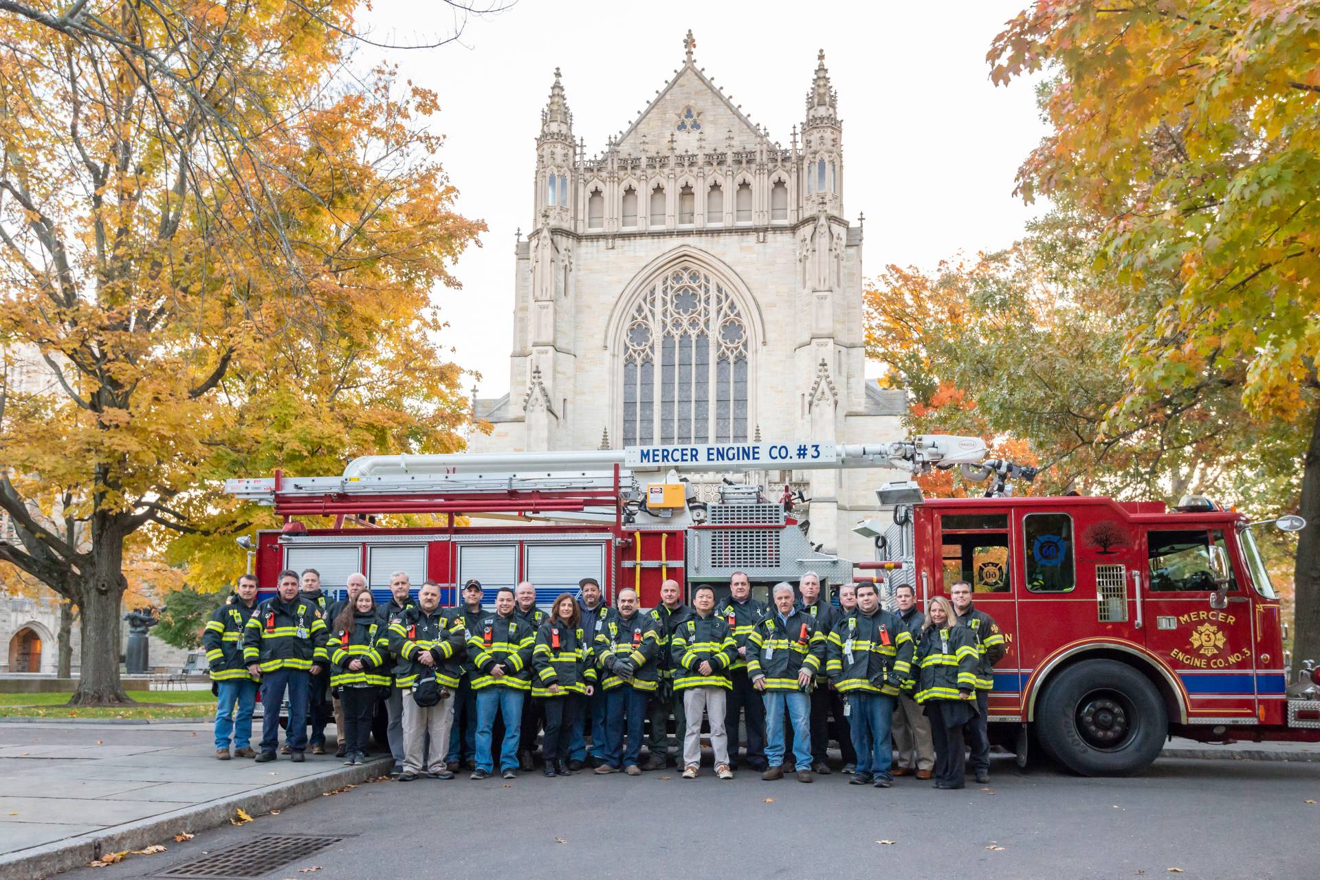 Fire engine, firefighters in front of chapel