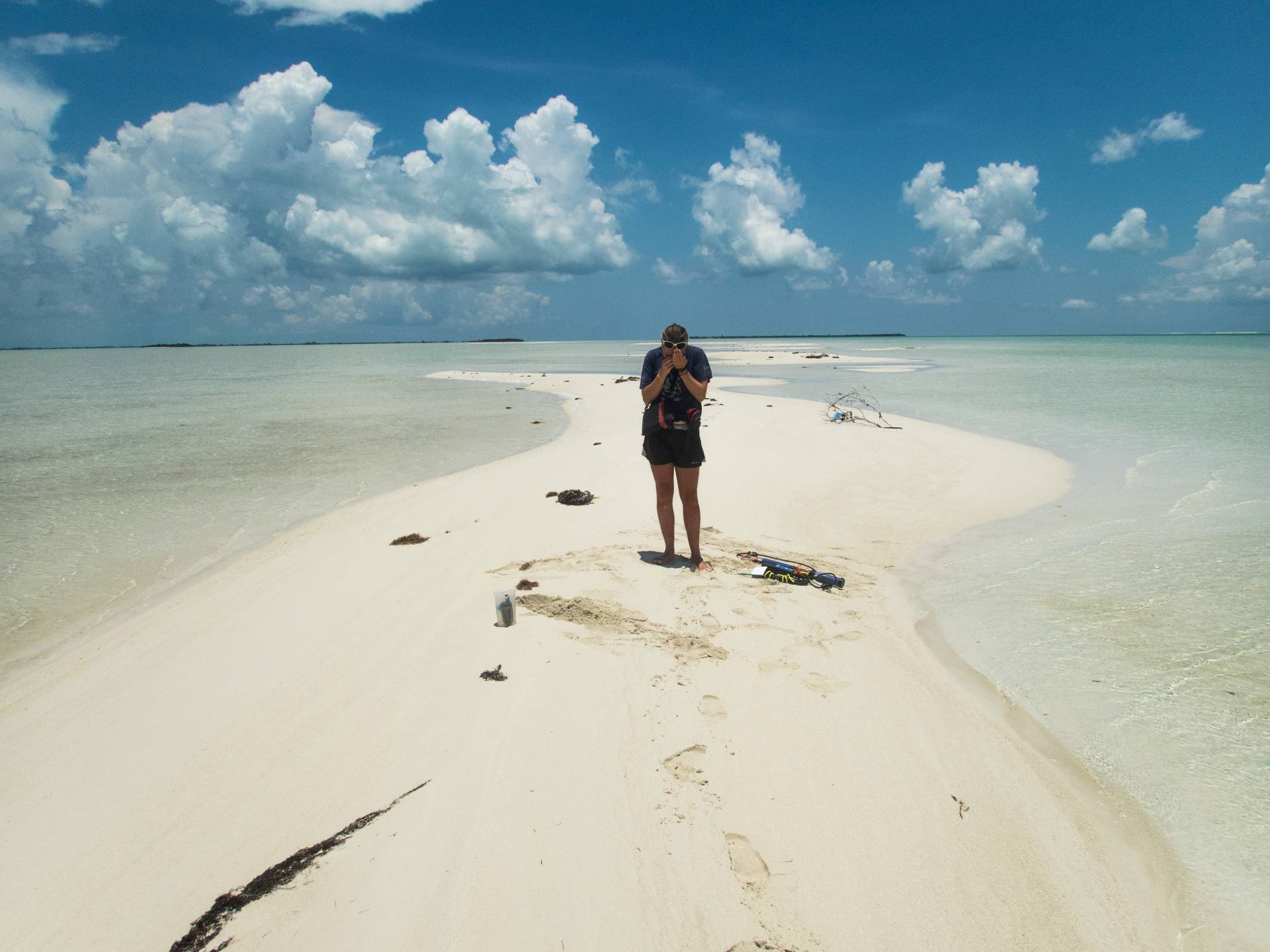 A student stands on a sand shoal