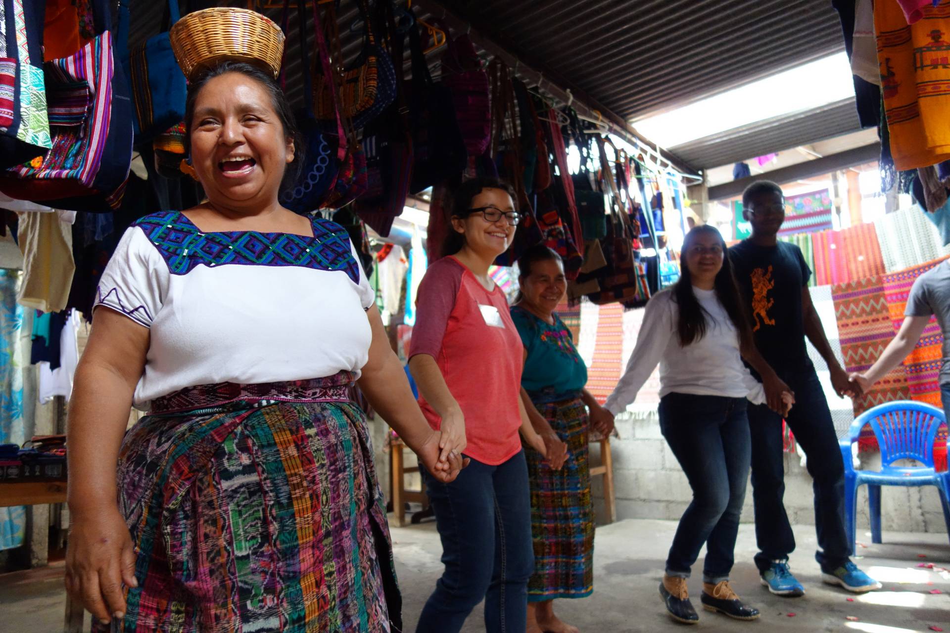 A Guatemalan woman leads a group of students in a dance