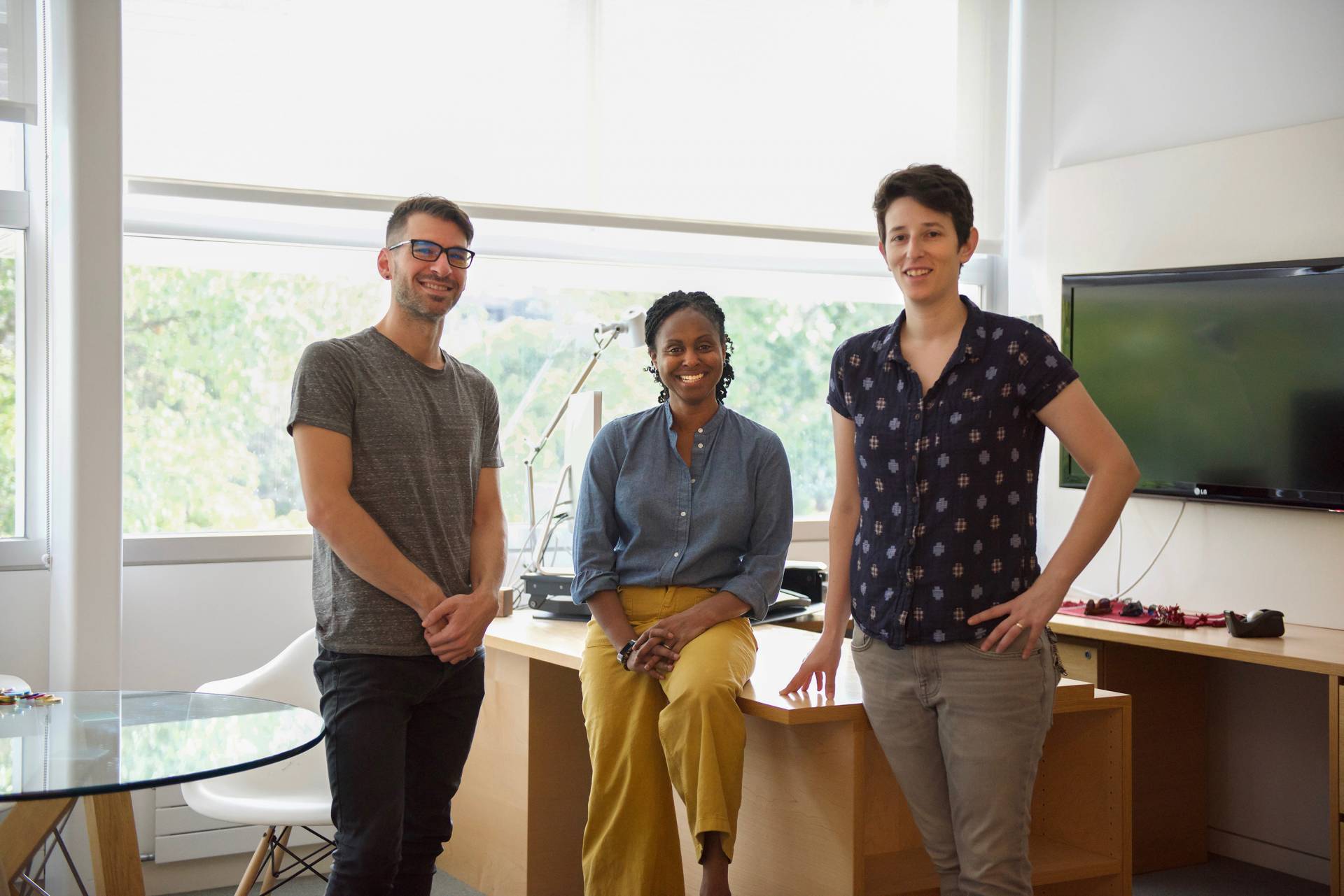 3 researchers in front of a desk