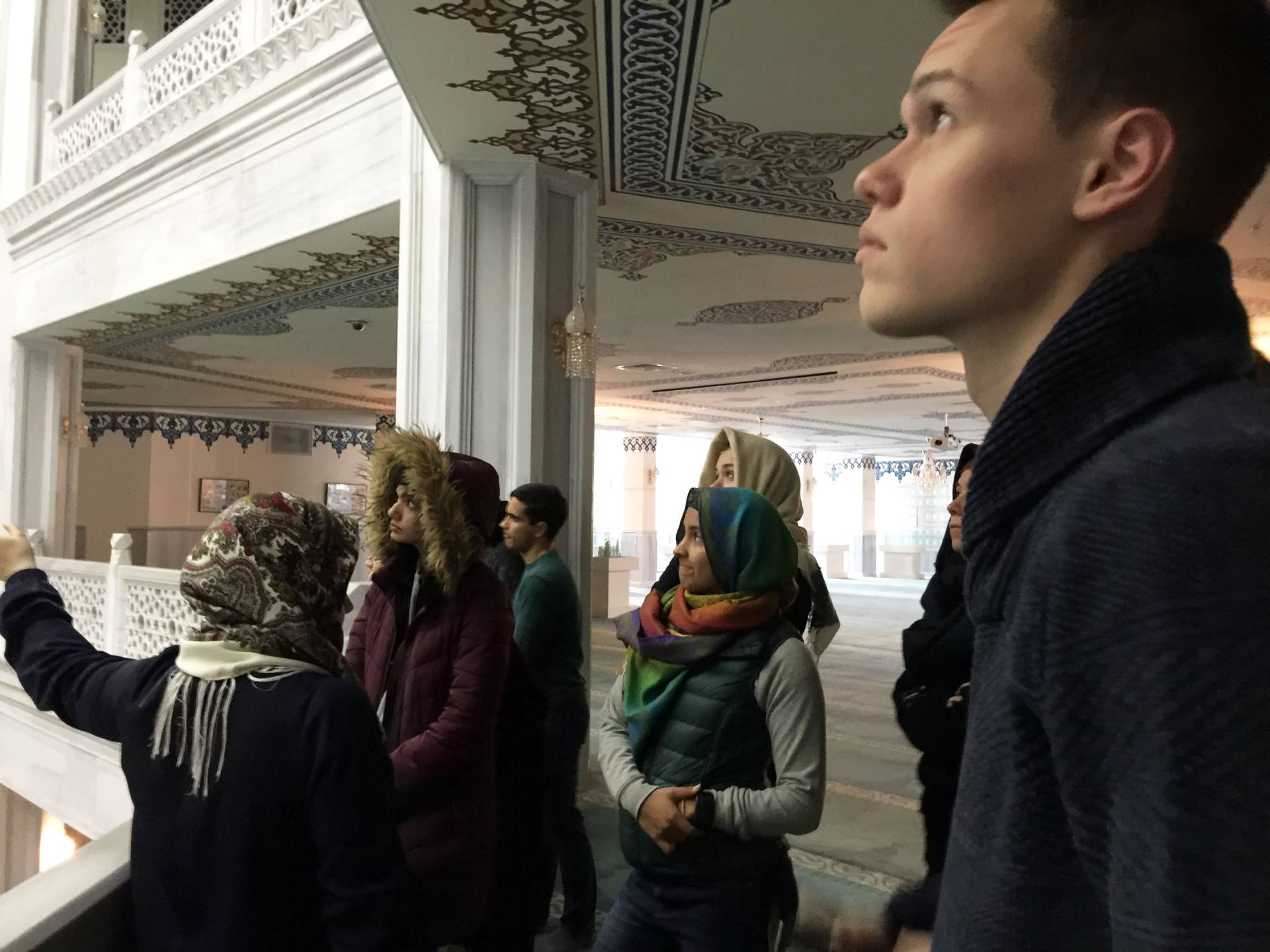 A group of students standing inside mosque