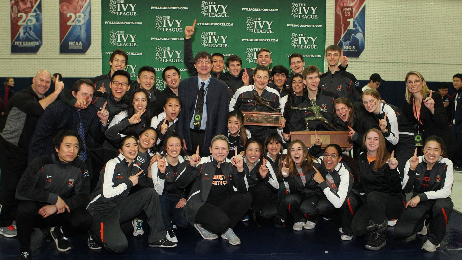 Princeton men's and women's fencing team poses with their championship trophies