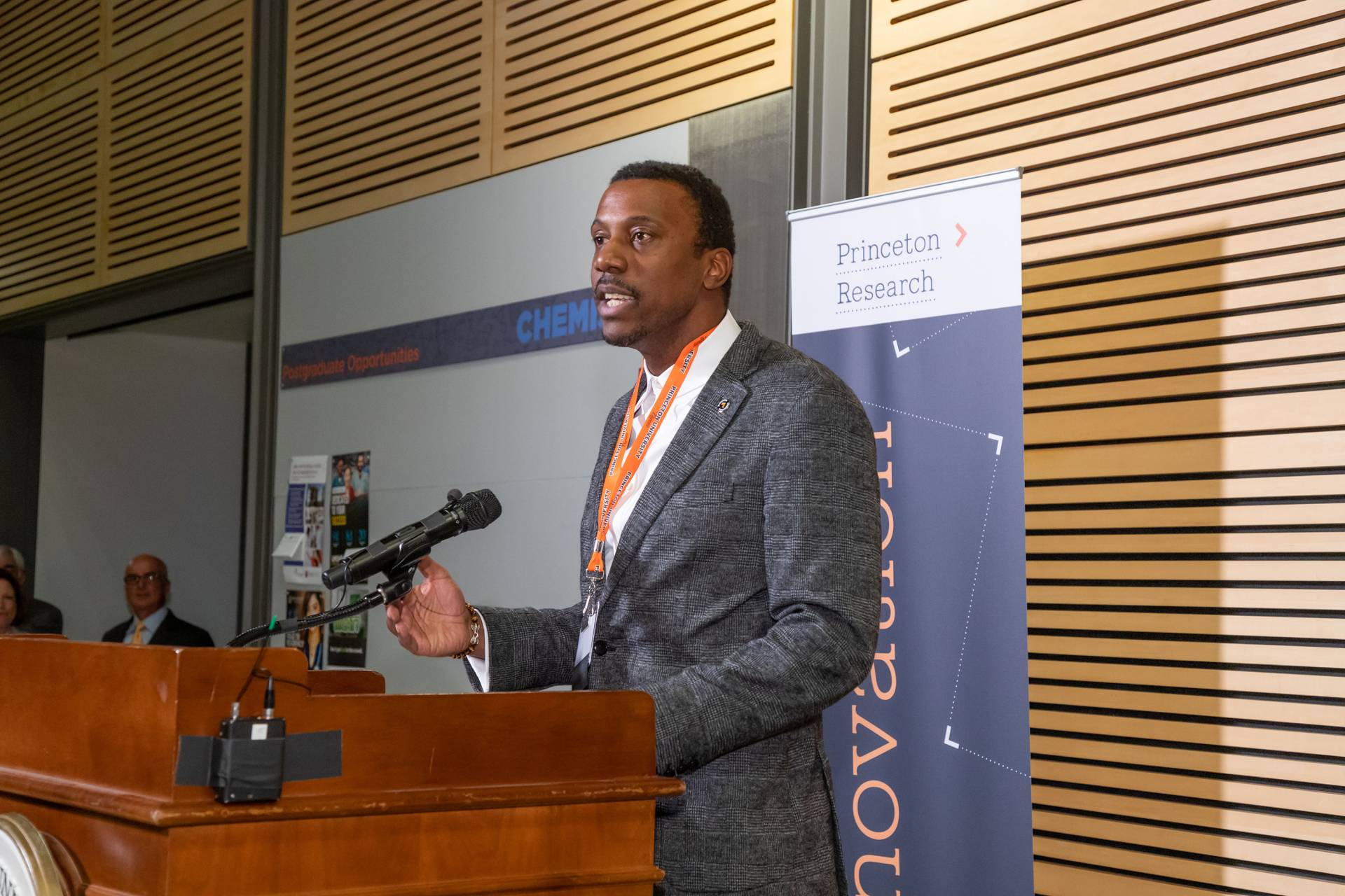 Rodney Priestley speaks at a podium during an event