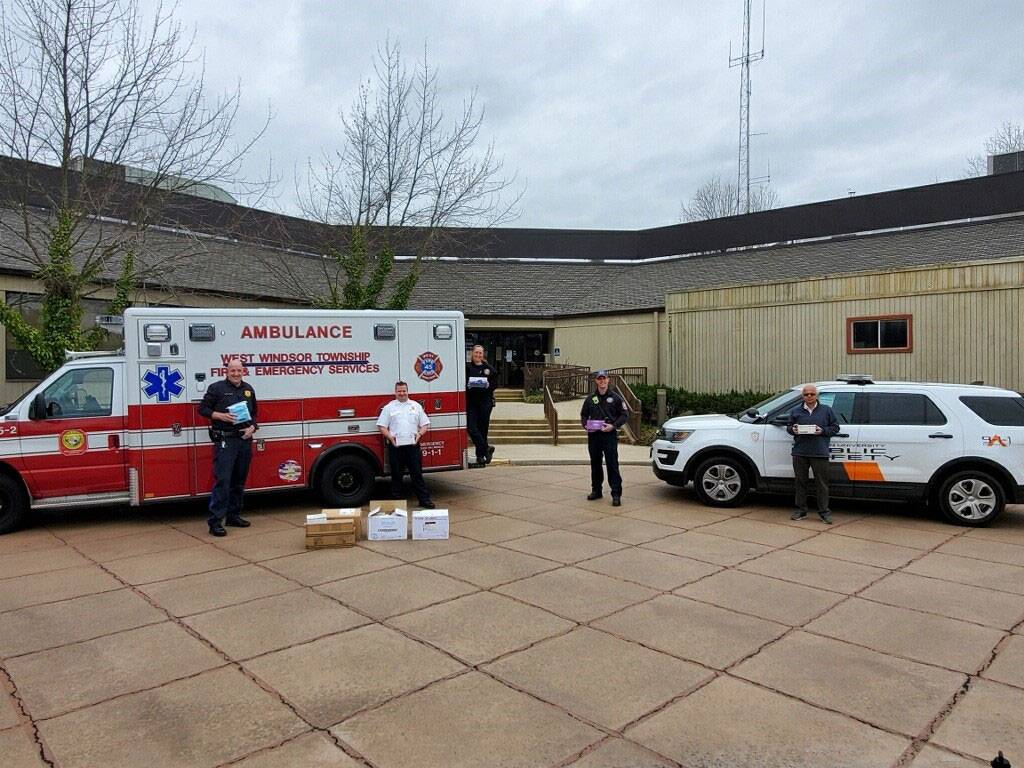 Staff pose with emergency vehicles and supplies in West Windsor