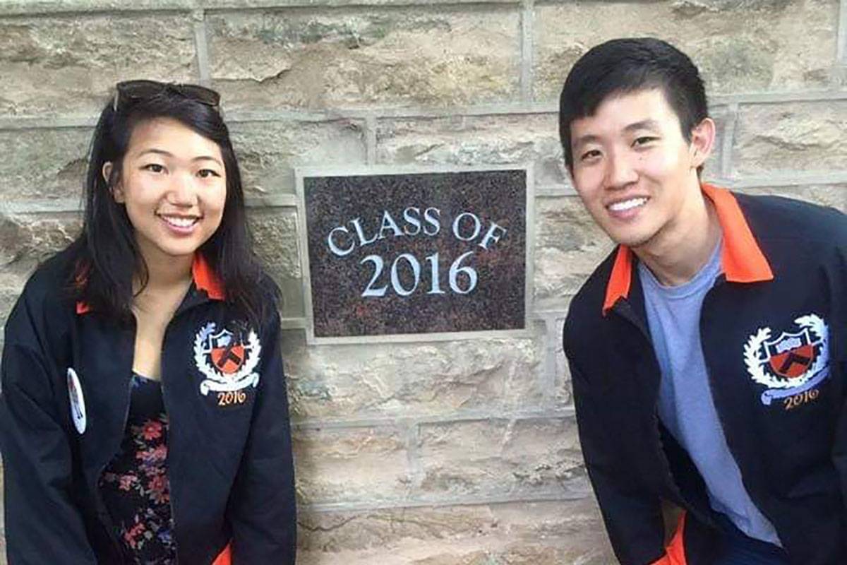 2 students pose in front of a Class of 2016 plaque