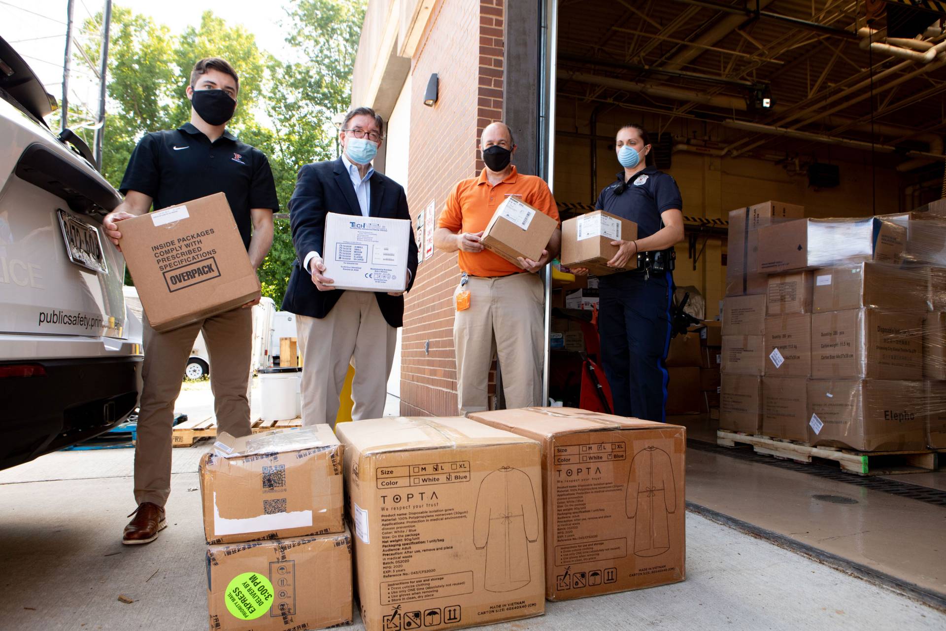 volunteers load boxes of PPE