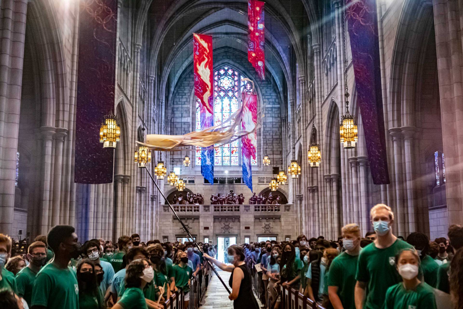 Students watch as the kite flyers walk up the chapel aisle