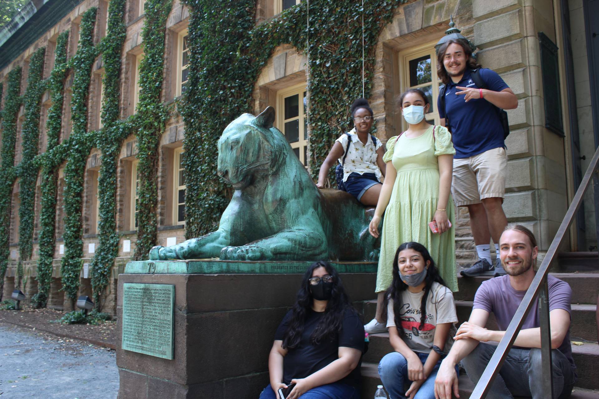 Students pose in front of tiger sculpture