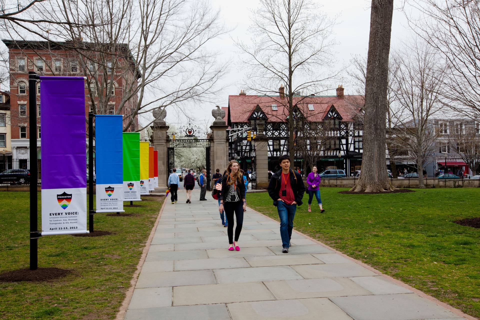 Conference attendees walk towards Nassau Hall, where rainbow flags have been installed for the occasion