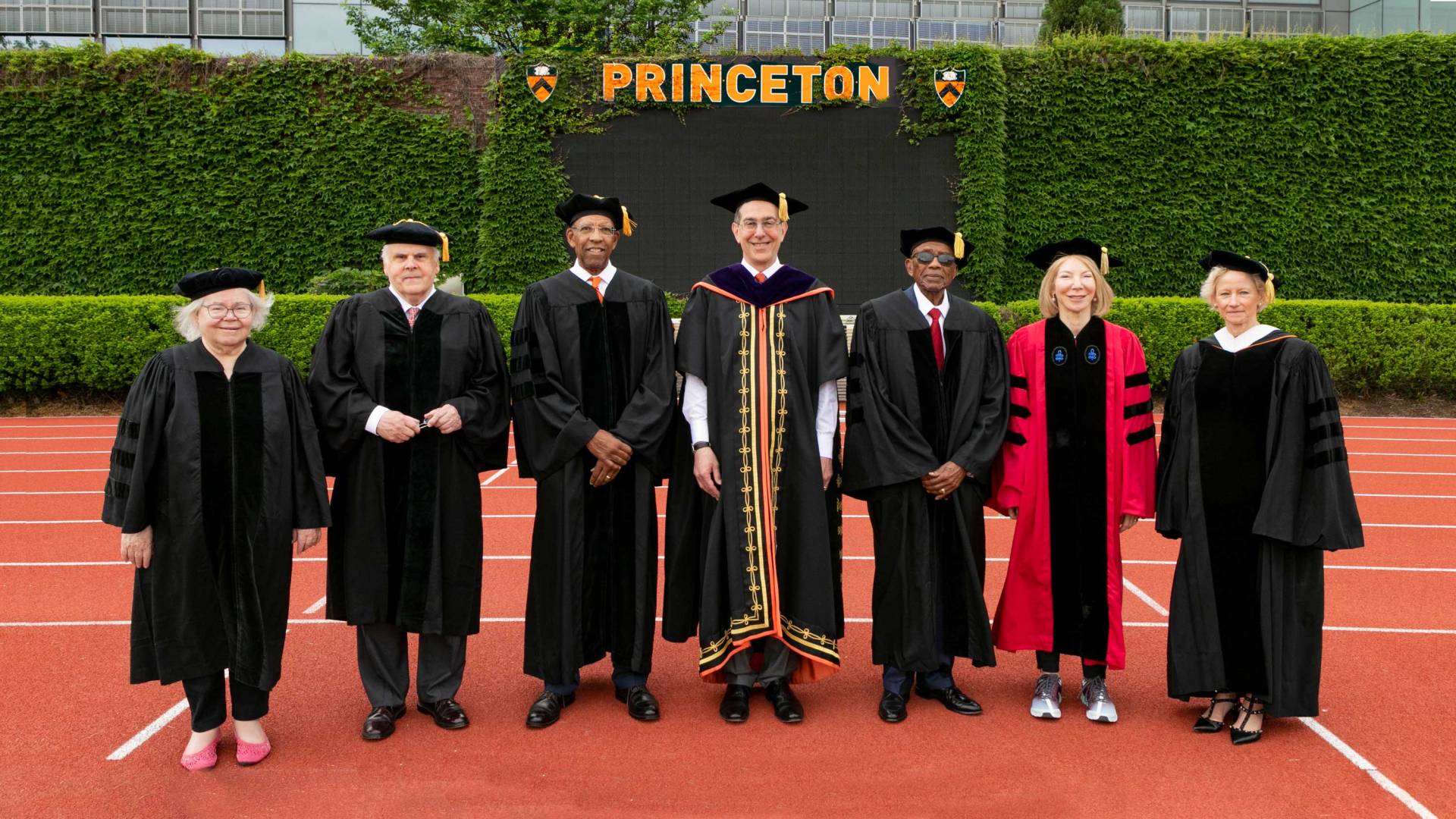 Honorary degree recipients and Christopher Eisgruber on Weaver Track