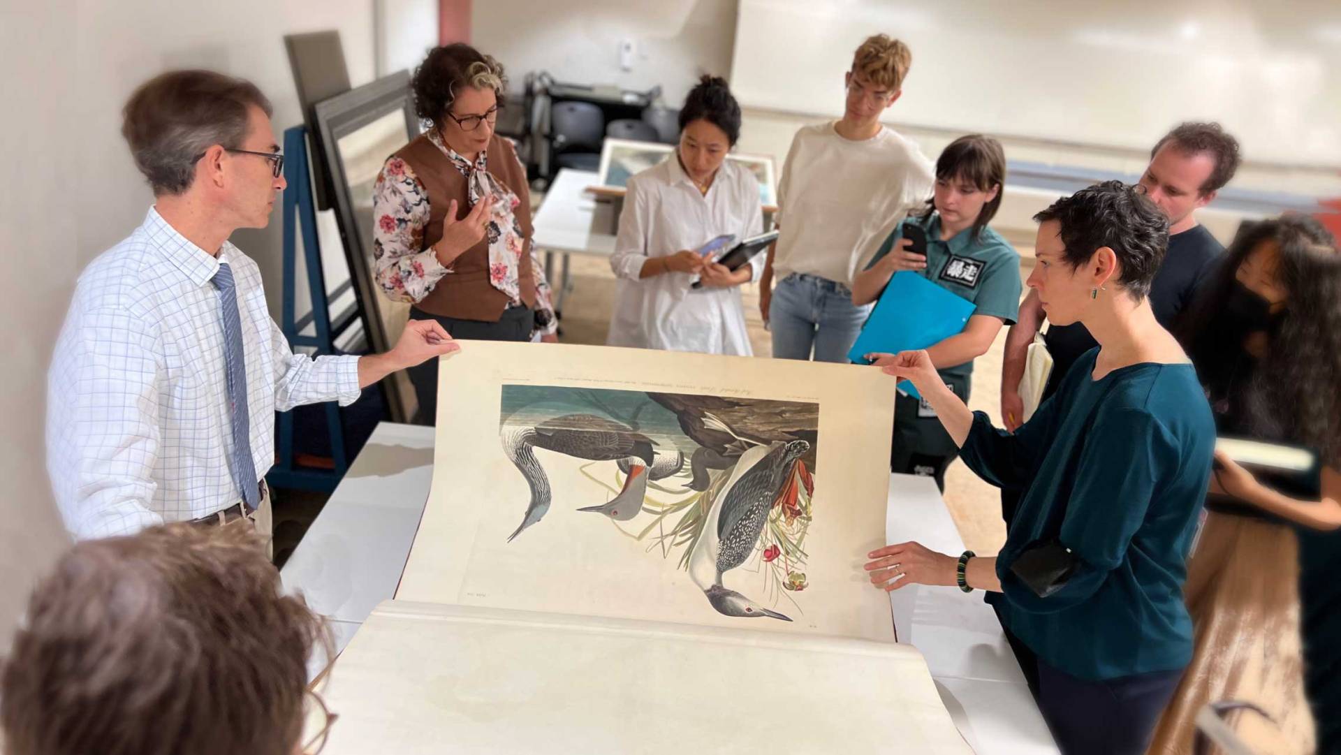 Rachael DeLue lectures about the bird print in a rare book