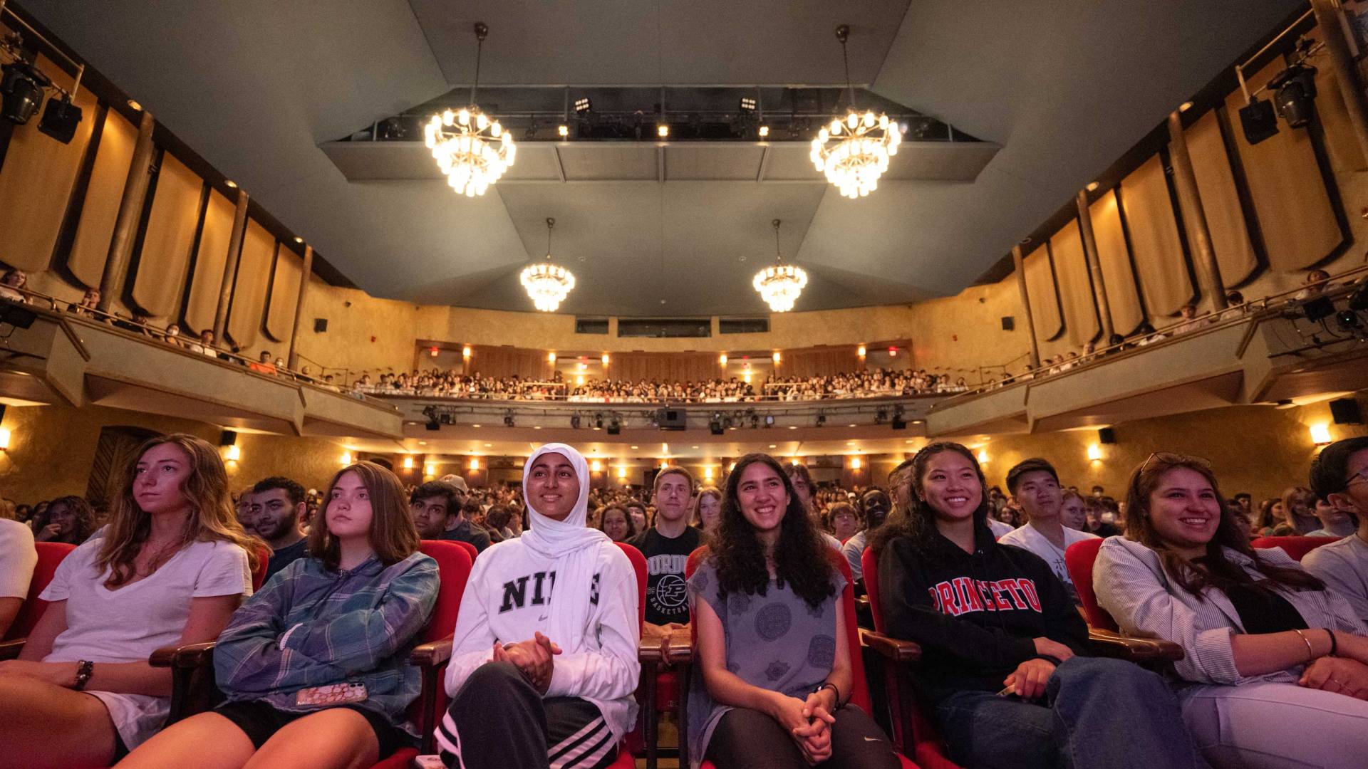 Students fill the seats of the auditorium