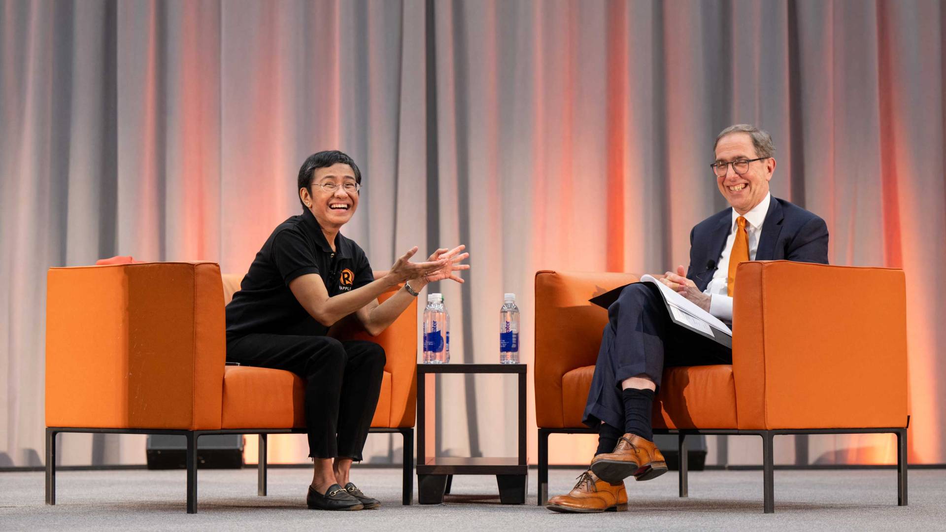 Maria Ressa and President Eisgruber share a light moment on stage
