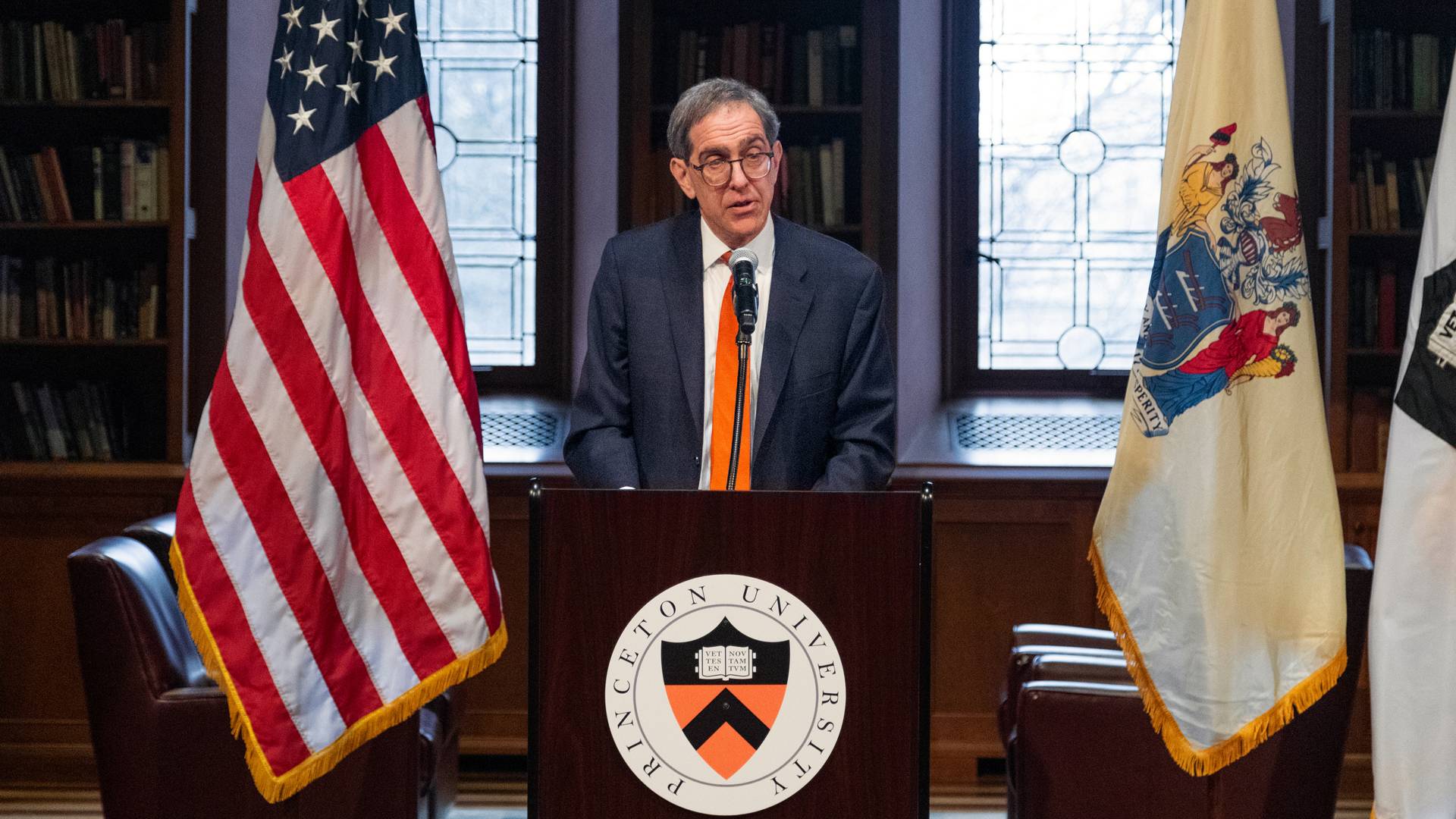 Princeton President Christopher L. Eisgruber speaking at a podium in the Chancellor Green Library in front of a large audience