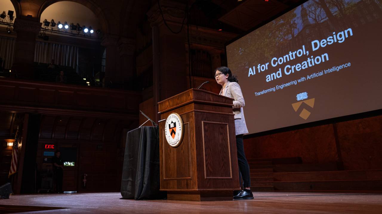 Mengdi Wang in front of a projection of the title of her talk "AI for Control, Design and Creation"