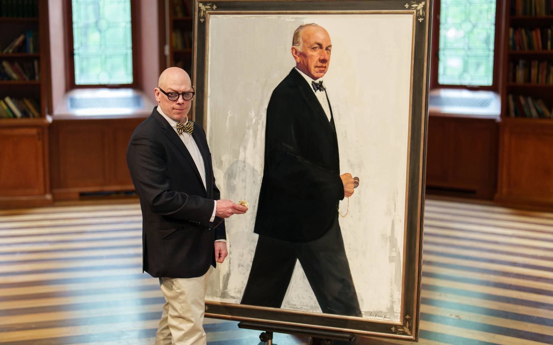 One of Jose Ferrer's sons, Rafael, poses in a similar way next to his father's portrait